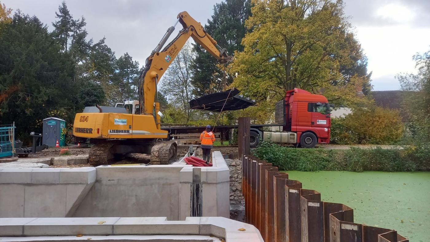 engin de chantier soulevant le clapet métallique au bord de l'écluse de Sainte Catherine à Pannes (Loiret).
